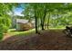 Exterior view of home from back yard featuring a wooden deck with stairs and mature trees at 323 Bells Ferry Ne Rd, White, GA 30184