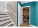 View of stairs to the second floor and basement access with colorful accent wall at 323 Bells Ferry Ne Rd, White, GA 30184