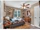 Inviting bedroom featuring a cozy quilt, wooden desk, and a ceiling fan at 323 Bells Ferry Ne Rd, White, GA 30184