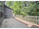 Backyard featuring a concrete patio and wood fence surrounded by lush trees at 1278 Houndslake Dr, Marietta, GA 30008