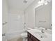 Bright bathroom with a large mirror, white cabinets, and a shower-tub combo at 1278 Houndslake Dr, Marietta, GA 30008