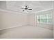 Spacious bedroom with neutral carpet, tray ceiling, and natural light at 1278 Houndslake Dr, Marietta, GA 30008