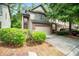 Charming townhome with a two-car garage, manicured bushes, and a well-maintained driveway at 1278 Houndslake Dr, Marietta, GA 30008
