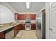 Well-equipped kitchen featuring stainless steel appliances, granite countertops, and dark wood cabinetry at 1278 Houndslake Dr, Marietta, GA 30008