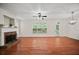 Spacious living room with fireplace, hardwood floors, ceiling fan, and natural light from large windows at 1278 Houndslake Dr, Marietta, GA 30008