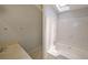 Well-lit bathroom featuring a soaking tub with white tile surround and a single sink vanity with a light countertop at 3087 Drexel Ln, Jonesboro, GA 30236