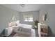 Cozy bedroom featuring a pull out trundle bed, large window, minimalist decor, and a soft striped rug at 3087 Drexel Ln, Jonesboro, GA 30236