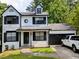 Charming two-story home with black trim, attached garage, and a well-manicured front lawn at 3087 Drexel Ln, Jonesboro, GA 30236