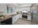 Bright kitchen with stainless steel appliances, granite countertops, and white cabinets at 3087 Drexel Ln, Jonesboro, GA 30236