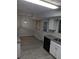 Eat-in kitchen with stainless sink, modern lighting, granite counters, and backyard door at 3087 Drexel Ln, Jonesboro, GA 30236