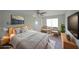 Bright staged bedroom with a ceiling fan, decorative rug, large bed, sitting area and ample natural light at 3087 Drexel Ln, Jonesboro, GA 30236
