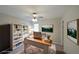 A stylishly decorated office space, featuring an organized bookcase and a wooden desk bathed in natural light at 3087 Drexel Ln, Jonesboro, GA 30236