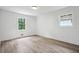 Well-lit bedroom with two windows, new hardwood floors and clean, white walls at 4148 Emerald North Dr, Decatur, GA 30035