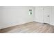 Clean bedroom featuring modern hardwood floors, white walls, and a sleek door at 4148 Emerald North Dr, Decatur, GA 30035