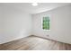 Bright bedroom with light-colored hardwood floors and a window providing natural light at 4148 Emerald North Dr, Decatur, GA 30035