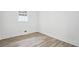 Bedroom featuring modern hardwood floors, white walls, and a window at 4148 Emerald North Dr, Decatur, GA 30035