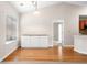 Dining area with hardwood floors, white cabinets, and a large window for natural light at 1452 Evanston Ln, Marietta, GA 30062