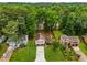 Beautiful home featuring a manicured front lawn and a two-car garage, nestled amongst mature trees at 2090 Rocky Mill Drive, Lawrenceville, GA 30044