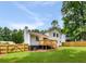 An expansive backyard featuring a large lawn, deck and mature trees at 2090 Rocky Mill Drive, Lawrenceville, GA 30044
