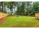 An expansive backyard featuring a large lawn, trees, and a wood fence at 2090 Rocky Mill Drive, Lawrenceville, GA 30044