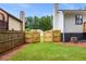 A grass backyard enclosed by a wood fence at 2090 Rocky Mill Drive, Lawrenceville, GA 30044