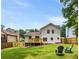 A spacious, well-manicured backyard with a deck, lawn and mature trees at 2090 Rocky Mill Drive, Lawrenceville, GA 30044