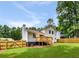 Well-maintained backyard with lush green lawn, wooden fence, and mature trees for privacy at 2090 Rocky Mill Drive, Lawrenceville, GA 30044