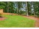 Spacious backyard with a well-manicured lawn, wooden fence, and mature trees at 2090 Rocky Mill Drive, Lawrenceville, GA 30044