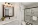 Modern bathroom with a walk-in shower, elegant vanity, a decorative mirror, and a stylish light fixture at 2090 Rocky Mill Drive, Lawrenceville, GA 30044