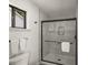 Modern bathroom with marble-style tile in the shower, a sleek glass door, and black hardware at 2090 Rocky Mill Drive, Lawrenceville, GA 30044