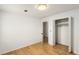 This bright bedroom features a hardwood floor, closet, and white walls at 2090 Rocky Mill Drive, Lawrenceville, GA 30044