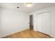 A bedroom featuring wood floors, a closet, and an open door to the hallway at 2090 Rocky Mill Drive, Lawrenceville, GA 30044