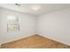 Minimalist bedroom with wood floors, natural light, and fresh white walls at 2090 Rocky Mill Drive, Lawrenceville, GA 30044