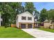 Charming two-story home with stone accents, two car garage and large front yard at 2090 Rocky Mill Drive, Lawrenceville, GA 30044