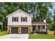 Charming two-story home with a stone-accented garage and a welcoming front porch at 2090 Rocky Mill Drive, Lawrenceville, GA 30044