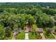 Aerial view showing single-Gathering homes nestled among the trees with well maintained yards at 2090 Rocky Mill Drive, Lawrenceville, GA 30044