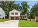 Charming two-story home with a stone-accented garage and a lush green lawn at 2090 Rocky Mill Drive, Lawrenceville, GA 30044