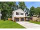 Two-story home features stone accents and a manicured lawn at 2090 Rocky Mill Drive, Lawrenceville, GA 30044