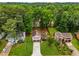 Aerial view of charming single Gathering homes nestled in lush green trees and manicured lawns at 2090 Rocky Mill Drive, Lawrenceville, GA 30044