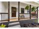 Inviting front porch with dark wood accents, hanging plants, and a cozy bench at 2090 Rocky Mill Drive, Lawrenceville, GA 30044
