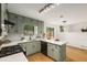 The remodeled kitchen features modern lighting, light green cabinets and new appliances at 2090 Rocky Mill Drive, Lawrenceville, GA 30044