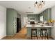 Charming kitchen with green cabinetry, white countertops, and modern pendant lighting at 2090 Rocky Mill Drive, Lawrenceville, GA 30044