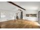 Open-concept living room with wood-look floors, beamed ceiling, and view to the kitchen at 2090 Rocky Mill Drive, Lawrenceville, GA 30044