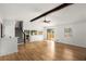 Large living room with wood-look floors, ceiling beam, stairs, and sliding door to backyard at 2090 Rocky Mill Drive, Lawrenceville, GA 30044