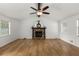 Bright living room features a vaulted ceiling, wood-look flooring and a cozy stone fireplace at 2090 Rocky Mill Drive, Lawrenceville, GA 30044
