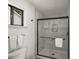 Sleek glass shower with gray tile and a built-in niche for toiletries at 2090 Rocky Mill Drive, Lawrenceville, GA 30044