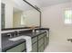 Bathroom boasts double vanity, green cabinetry, and a sleek, modern design, creating a spa-like experience at 38 Mildred Nw Pl, Atlanta, GA 30318