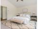 Comfortable main bedroom with a large bed, bench, rug, and bedside tables at 38 Mildred Nw Pl, Atlanta, GA 30318