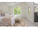 Bright bedroom featuring large window, neutral tones, and carpet flooring creating a cozy and inviting space at 38 Mildred Nw Pl, Atlanta, GA 30318