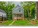 Two-story home with light grey siding, white trim, and a covered porch at 38 Mildred Nw Pl, Atlanta, GA 30318